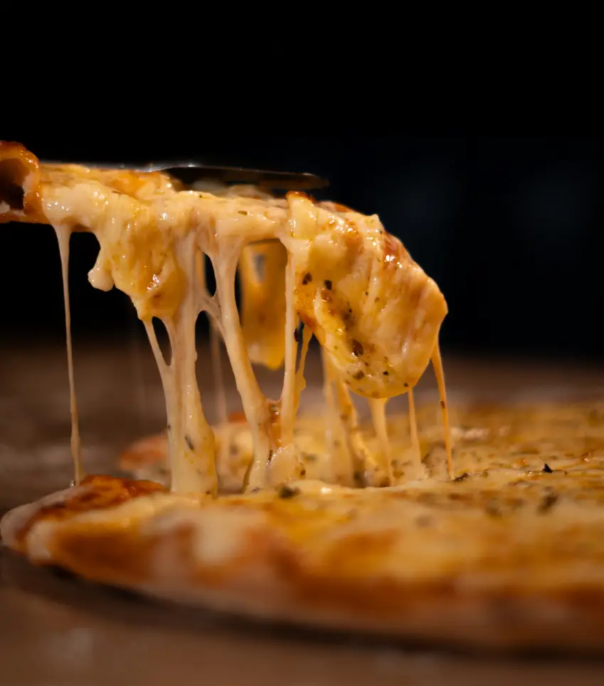 tomato-sauce-being-spooned-pizza 2